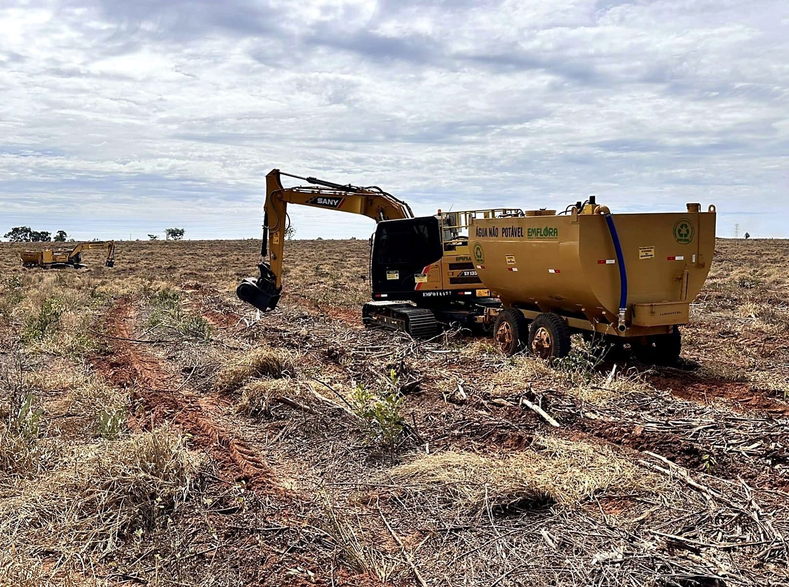 Emflora excavator performing mechanized irrigation